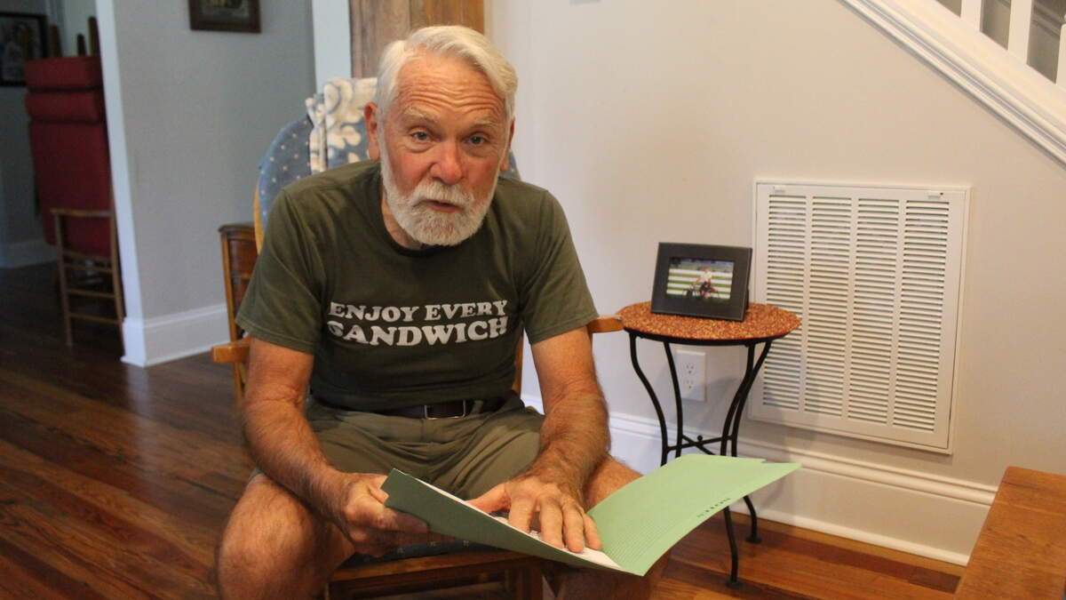 George Garber, 72, holds a diary logging decades of mental health-related incidents related to his stepson, Damian Hisle, 52, on Monday, Aug. 24, 2026, at his home in Lexington, Kentucky.